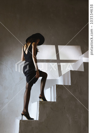 Woman walk on stairs in high heels Woman walk on stairs in high heels 103534638