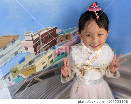 A girl in Korean national costume touring Gamcheon Culture Village in Busan 103535168