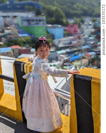 A girl in Korean national costume touring Gamcheon Culture Village in Busan 103535172
