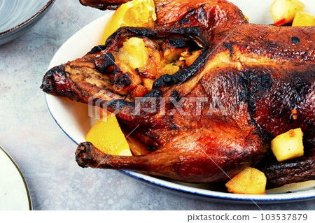 Roast duck with apples and orange Roast duck with apples and orange 103537879