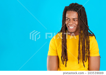 Distracted smiley latin man with dreadlocks Distracted smiley latin man with dreadlocks 103539089