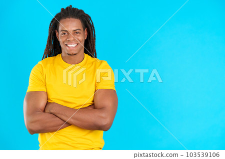 Happy latin man with dreadlocks standing with arms crossed Happy latin man with dreadlocks standing with arms crossed 103539106