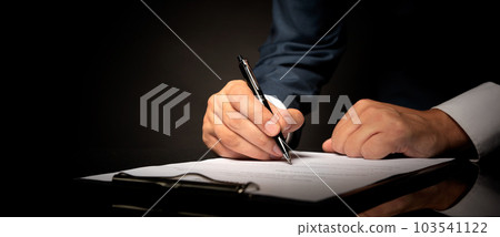 Notary public in office signing document 103541122