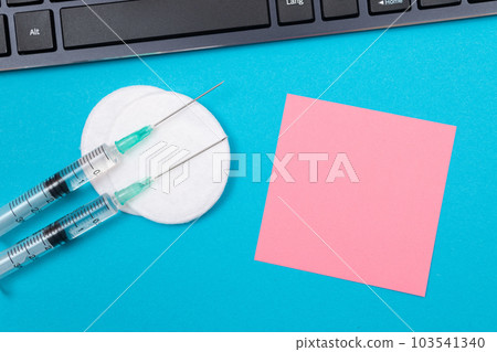 Vaccination or Revaccination Concept - Two Medical Syringe on Blue Table 103541340