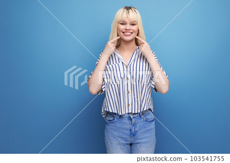 smiling blond 25 year old female person in striped blouse and jeans posing as a model smiling blond 25 year old female person in striped blouse and jeans posing as a model 103541755