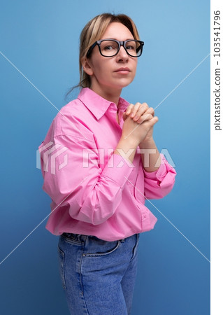 young smart blond caucasian secretary woman with glasses and ponytail dressed in a pink blouse young smart blond caucasian secretary woman with glasses and ponytail dressed in a pink blouse 103541796