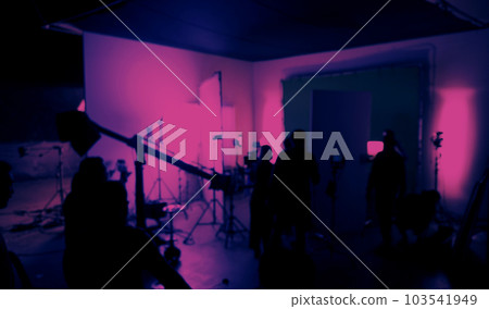 Blurry images of film crew working and filming in video production studio which using equipments such as cinema camera big film light and soft box or light diffusion panel. TV Commercial Film industry Blurry images of film crew working and filming in video production studio which using equipments such as cinema camera big film light and soft box or light diffusion panel. TV Commercial Film industry 103541949