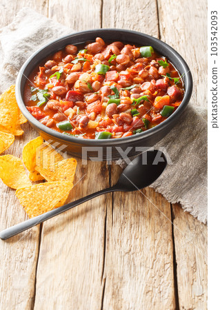 Frijoles charros or charros beans mexican traditional food with chorizo bacon and onions spicy food closeup on the bowl. Vertical 103542093