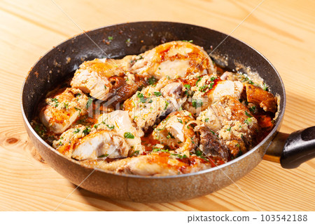 Shkmeruli, chicken in garlic sauce on a frying pan Shkmeruli, chicken in garlic sauce on a frying pan 103542188