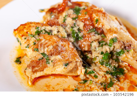 Shkmeruli is a traditional Georgian dish of chicken in garlic sauce in the white plate 103542196