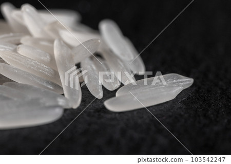 White rice on a black graphite stone slab 103542247
