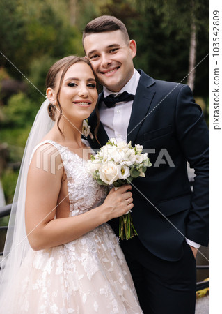 Portrait of gorgeous bride in wedding dress standing outdoors. Beautiful bride in elegant dress 103542809