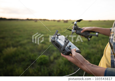 Farmer controls drone. Smart farming and precision agriculture Farmer controls drone. Smart farming and precision agriculture 103543817