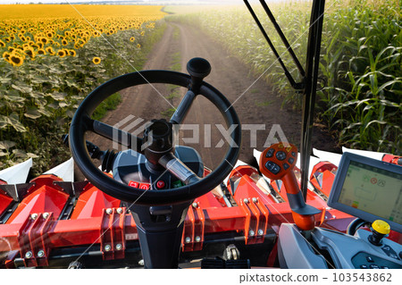 Autonomous combine harvester working on the field. Smart farming.. 103543862