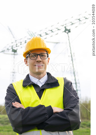 Engineer on a background of power line tower Engineer on a background of power line tower 103544089