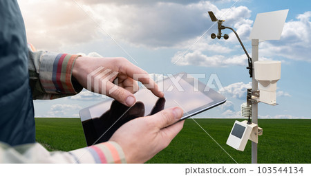 Farmer control weather station via digital tablet. Precision and smart farming equipment Farmer control weather station via digital tablet. Precision and smart farming equipment 103544134
