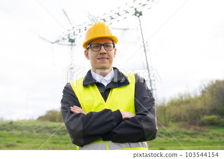 Engineer on a background of power line tower 103544154