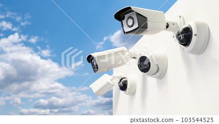 Surveillance cameras on a background of blue sky. Perimeter security. 103544525