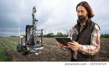 Farmer controls autonomous robot for measuring soil quality in an agricultural field. Farmer controls autonomous robot for measuring soil quality in an agricultural field. 103544724