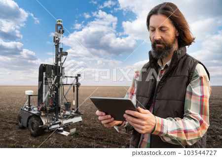 Farmer controls autonomous robot for measuring soil quality in an agricultural field. Farmer controls autonomous robot for measuring soil quality in an agricultural field. 103544727