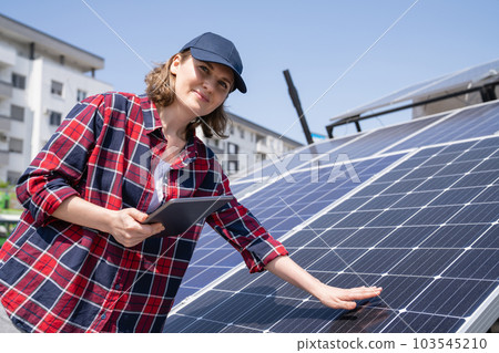 Woman with solar panel Woman with solar panel 103545210