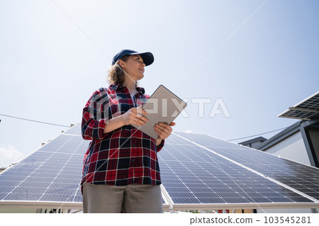 Woman with tablet on a background of mobile solar power station.. Woman with tablet on a background of mobile solar power station.. 103545281