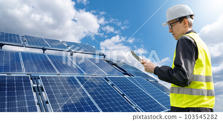 Engineer with tablet computer on a background of mobile solar power station Engineer with tablet computer on a background of mobile solar power station 103545282