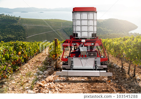 Autonomous robot sprayer works in a vineyard. 103545288