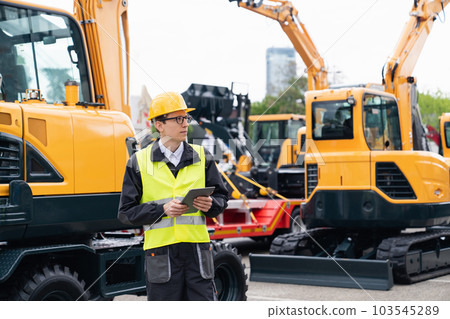 Engineer in a helmet with a digital tablet 103545289
