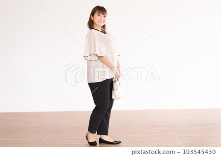 Chubby young woman business casual plus size model 103545430