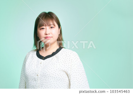 Plump young woman looking at her business casual 103545463