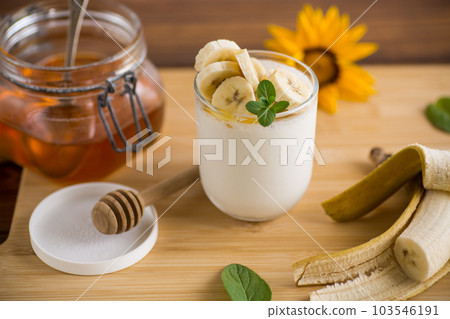 Sweet homemade yogurt with bananas and honey Sweet homemade yogurt with bananas and honey 103546191
