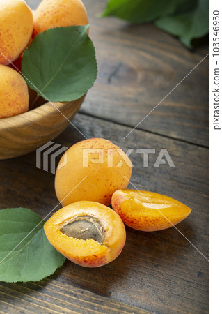 Delicious ripe apricots and leaves Delicious ripe apricots and leaves 103546930