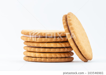 Sandwich cookies lie one on top of the other, isolated on a white background. 103546981
