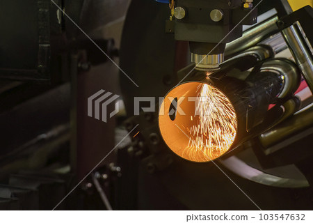 Close up scene the fiber laser cutting machine cutting  machine cut the stainless steel tube. 103547632