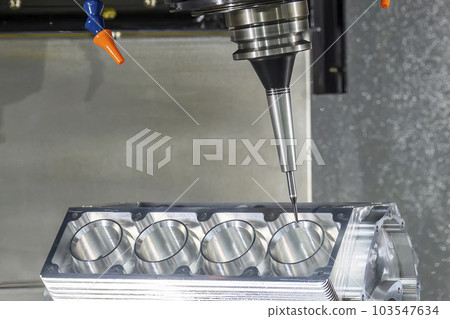 Close up scene the 5-axis machining center cutting the V8 engine cylinder block with solid ball end mill tool. Close up scene the 5-axis machining center cutting the V8 engine cylinder block with solid ball end mill tool. 103547634