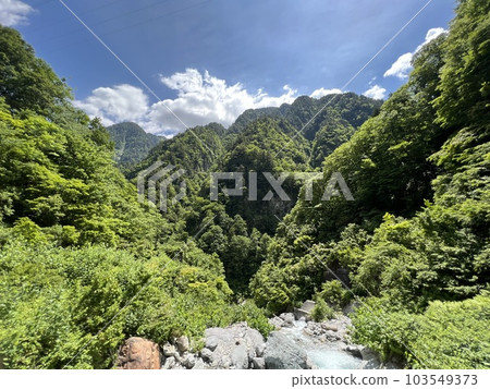 majestic canyon peaks and white clouds in the blue sky 103549373