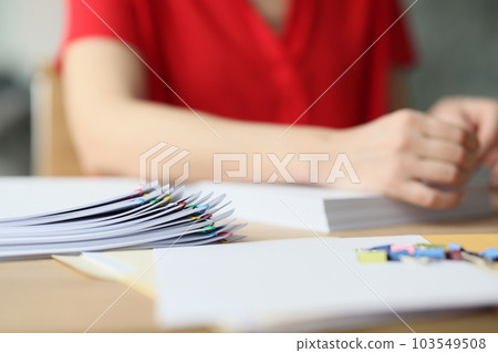 Secretary folds documents fastening with pins in office Secretary folds documents fastening with pins in office 103549508