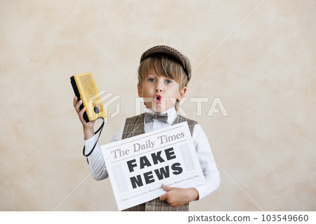 Newsboy shouting against grunge wall background. Boy selling fake news Newsboy shouting against grunge wall background. Boy selling fake news 103549660