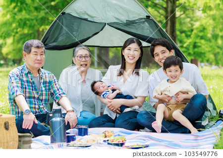 Three generation family enjoying camping Three generation family enjoying camping 103549776