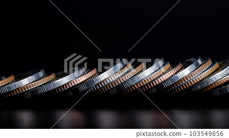 Close up of Coins are lined up in front on table. background is black. business and finance concept. 103549856