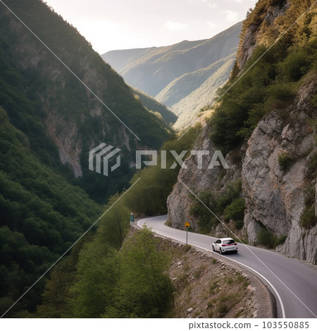Dangerous narrow winding mountain road near an abyss, a car drives along the road, view from afar 103550885
