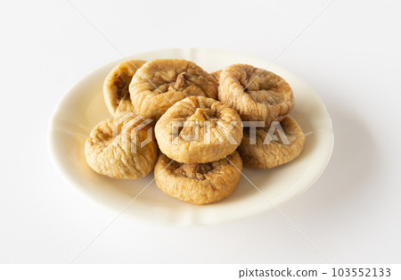 Dried figs and dried fruits served on a plate 103552133
