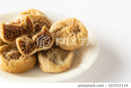 Dried figs and dried fruits served on a plate 103552134
