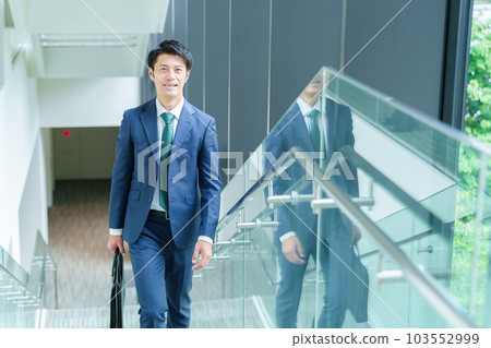 Businessman moving up the stairs Businessman moving up the stairs 103552999