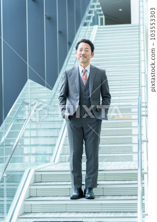 Senior businessman moving up the stairs 103553303