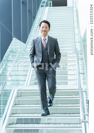 Senior businessman moving up the stairs 103553304