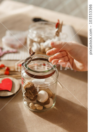 Children's hands collect a sweet gift for Valentine's Day. A gift for the holiday, a video blog entry. 103553366