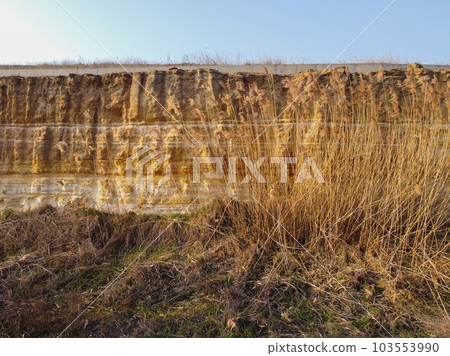 yellow and brown dirt texture background, with small rocks and dust. yellow and brown dirt texture background, with small rocks and dust. 103553990
