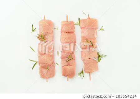 Chicken skewers.Chicken breast Fillets.Procurement for designers.Ogranic food,healthy eating.Skewers from raw chicken meat fillet for supermarket on white background.Food for retail. 103554214